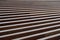 Parallel wooden slats painted with brown paint, background