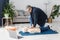 Paramedic demonstrating first aid on manikin during training alone in living room