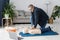 Paramedic demonstrating first aid on manikin during training alone in living room