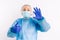 A paramedic in a protective guard looks at the camera showing the class and holds a vaccine from covid 19 in his hands