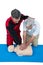 Paramedic training cardiopulmonary resuscitation to senior man