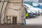 Paramedic wearing protective equipment disinfecting mobile testing station tent for cars