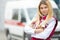 Paramedic worker with phonendoscope at emergency car background