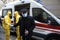 Paramedics helping an infected old man in mask to get from an ambulance car, coronavirus