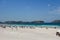 Paramotor flyes over Praia do Forte beach in Cabo Frio, Rio de Janeiro, Brazil