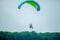 Paramotor flying in the air over the forest