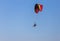 Paramotor flying on blue sky background