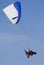 Paramotor glider in blue sky