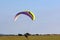 Paramotor pilot landing in a field