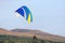 Paramotor pilot taking off from a field