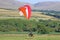 Paramotor pilot taking off from a field