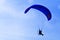 Paramotor silhouette in blue sky