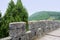 Parapet and walkway of ancient Chinese wall on mountain in summer green