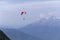 Paraplane on the blue sky background and mountains, leisure activity.