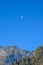 Paraplaners in tandem gliding in blue sky and Alpine mountains on paraplane