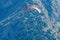 Paraplaners in tandem gliding in blue sky and Alpine mountains on paraplane