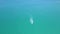 Parasail flying over blue sea pulled boat aerial view. Parasailing over blue sea drone view. Summer activity and extreme