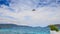 Parasailer starts fly from beach over sea against sky on island