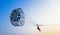 Parasailing extreme sports on beach in blue sky background.