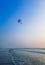 Parasailing extreme sports on beach in blue sky background.