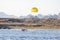 Parasailing parachute active sport sky sea boat. A speedboat pulls a yellow parachute with a tourist. Extreme entertainment for