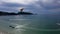 Parasailing in Phuket. A long shot of a man flying in the sky with help of colorful parasail wing or Parachute on a