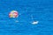 Parasailing towed behind a boat in the Caribbean sea, tropical Ocean, Vacation Concept, Cancun, Mexico