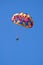 Parasailing under blue sky.