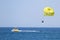 Parasailing with yellow flag.