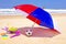 Parasol, toys and ball at the beach