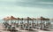 Parasols with deckchairs on the beach. Nerja, Spain