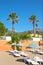 Parasols on sandy beach in exotic resort.