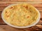 Paratha, isolated over a rustic wooden background, selective focus