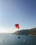 A paratrooper flies over the sea against the backdrop of a beautiful sunset and boats. Phuket Island,