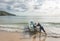 PARATY, RIO DE JANEIRO, BRAZIL - DECEMBER 29, 2019:  Man pushes boat in Praia Do Sono, Paraty, Brazil