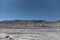 Parched river in the desert against the backdrop of mountains