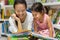 Parent and child reading books together in the library