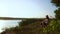 Parent and child spending time together fishing on river bank