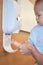 Parent cleaning toddler hand with waterless hand sanitizer, anti-bacterial hand disinfectant from sanitizer dispenser - Selective