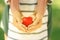 Parent and daughter holding heart in hands, closeup