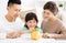 Parent and daughter putting coins into piggy bank