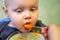 Parent feeds baby a pumpkin with a spoon