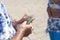 Parent gives money to the child, close-up, outdoors