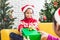 Parent giving Christmas gift box to asian child girl on Christmas celebration