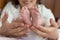 Parent hands gently holding baby feet from below