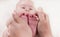 Parent holds gentle little beautiful feet in a newborn baby