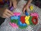 Parent and kid playing with educational toy, stacking and arranging colorful pieces with letters