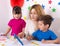 Parent learning and playing with kids. Mother or teacher painting or learning english letters with children.Homeschooling