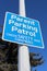 Parent Parking Patrol Sign Against Tree and Blue Sky