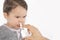Parent\'s hand of a sick little girl applies a nasal spray
